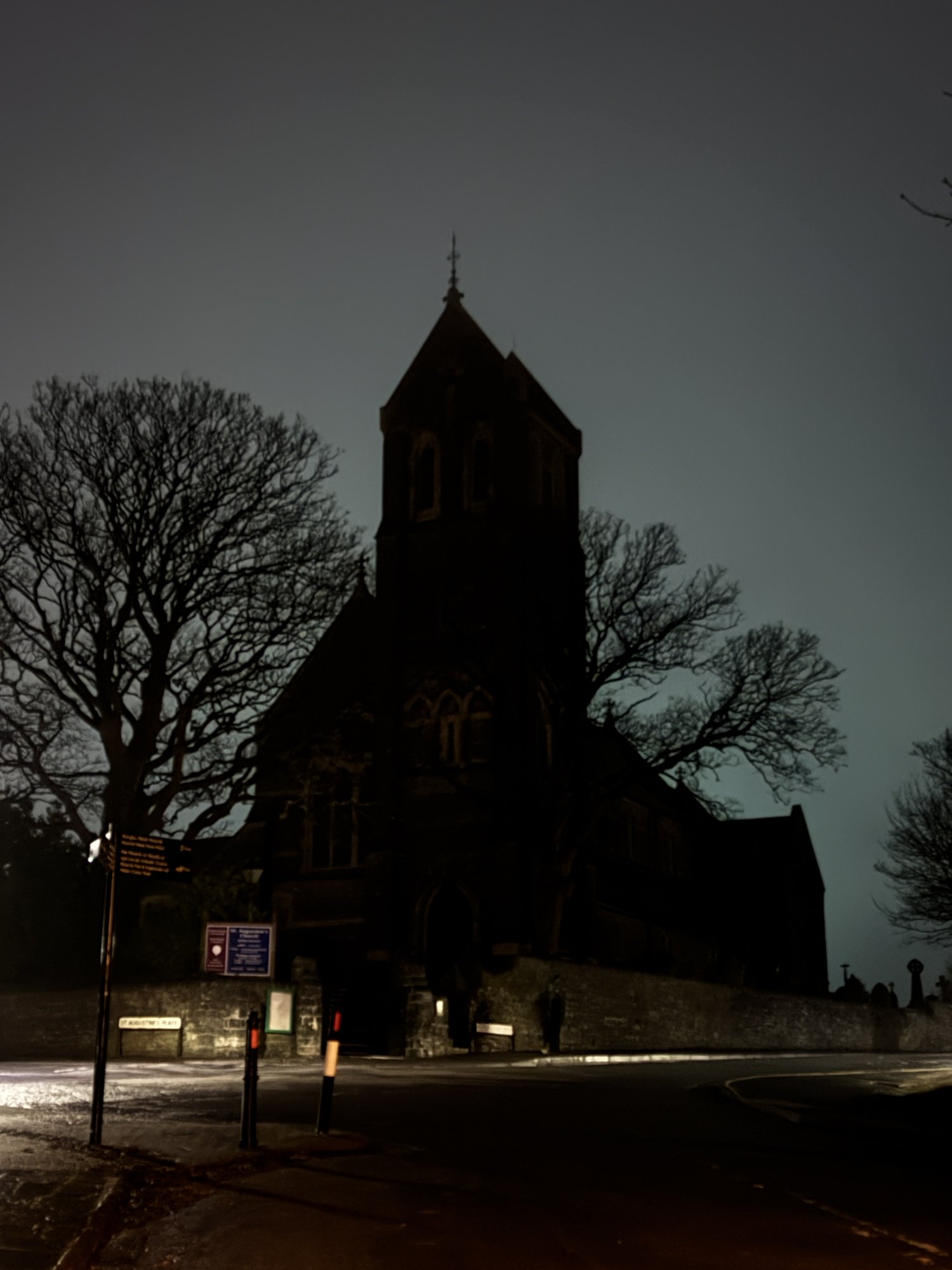 St Augustine's Church as a dark silhouette against the night sky over Penarth Head