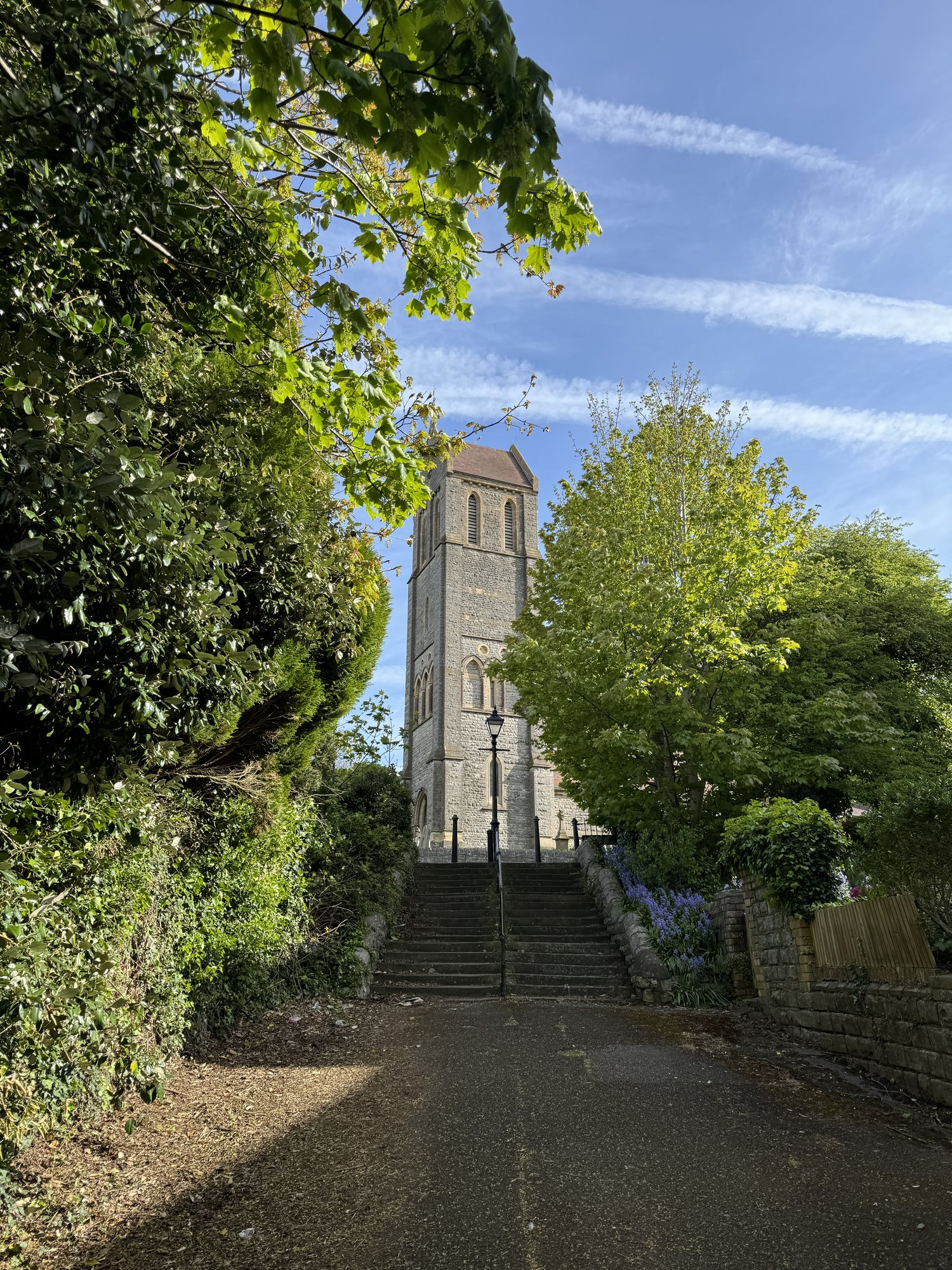 St Augustine's tower framed by summer greenery at the top of the steps