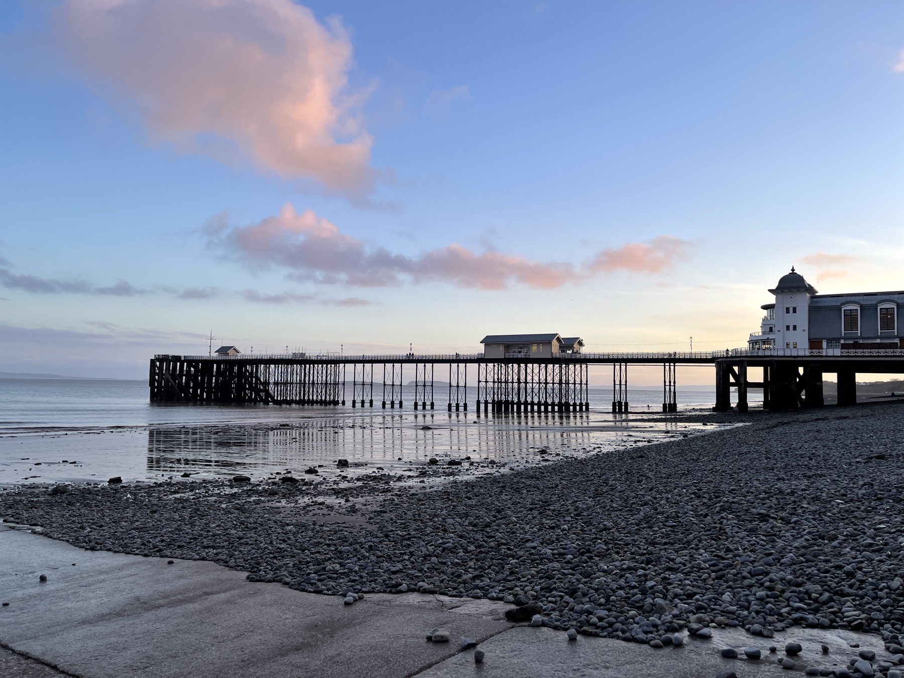 Penarth Pier Pavilion and beach at low tide in evening light