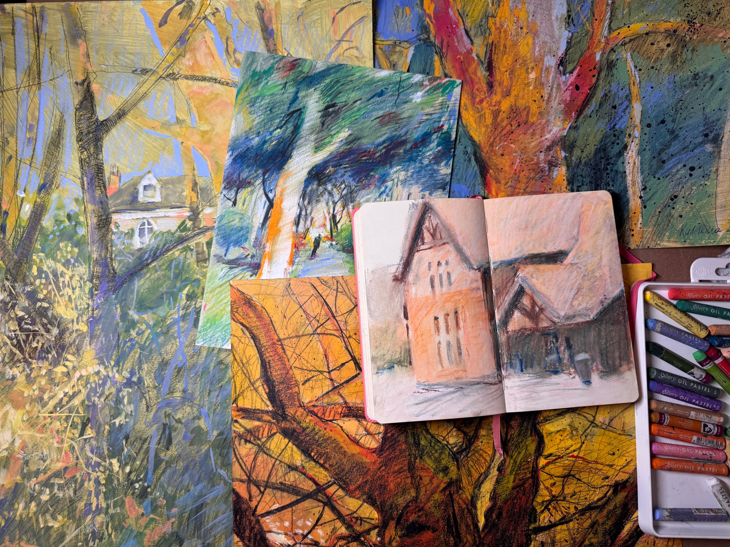 Ksenia Kudelkina's colourful paintings, sketchbook, and oil pastels in the studio